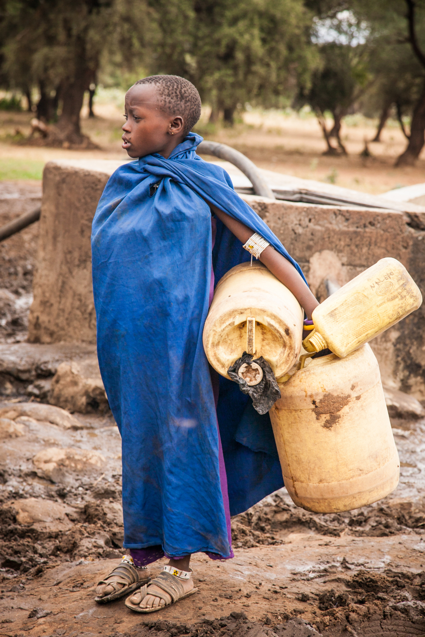 Photo of girl holding water containers