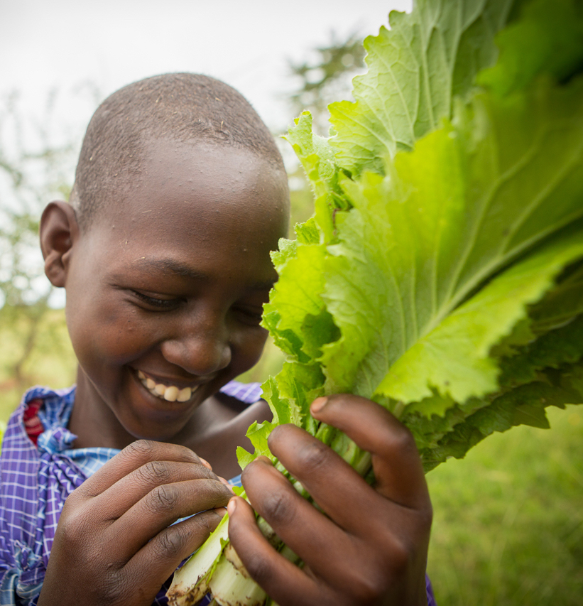 Photo of girl holding greens